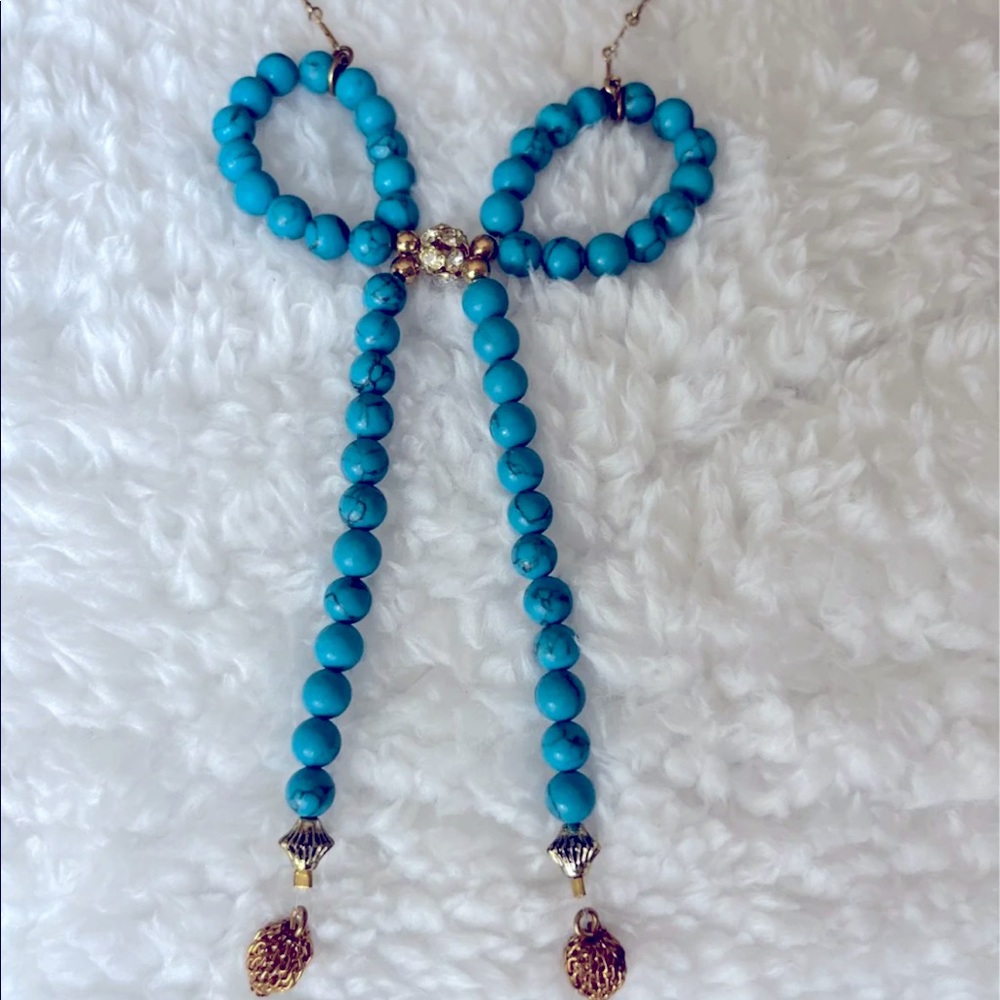 Anthropologie brand turquoise colored beads in a bowl design necklace.